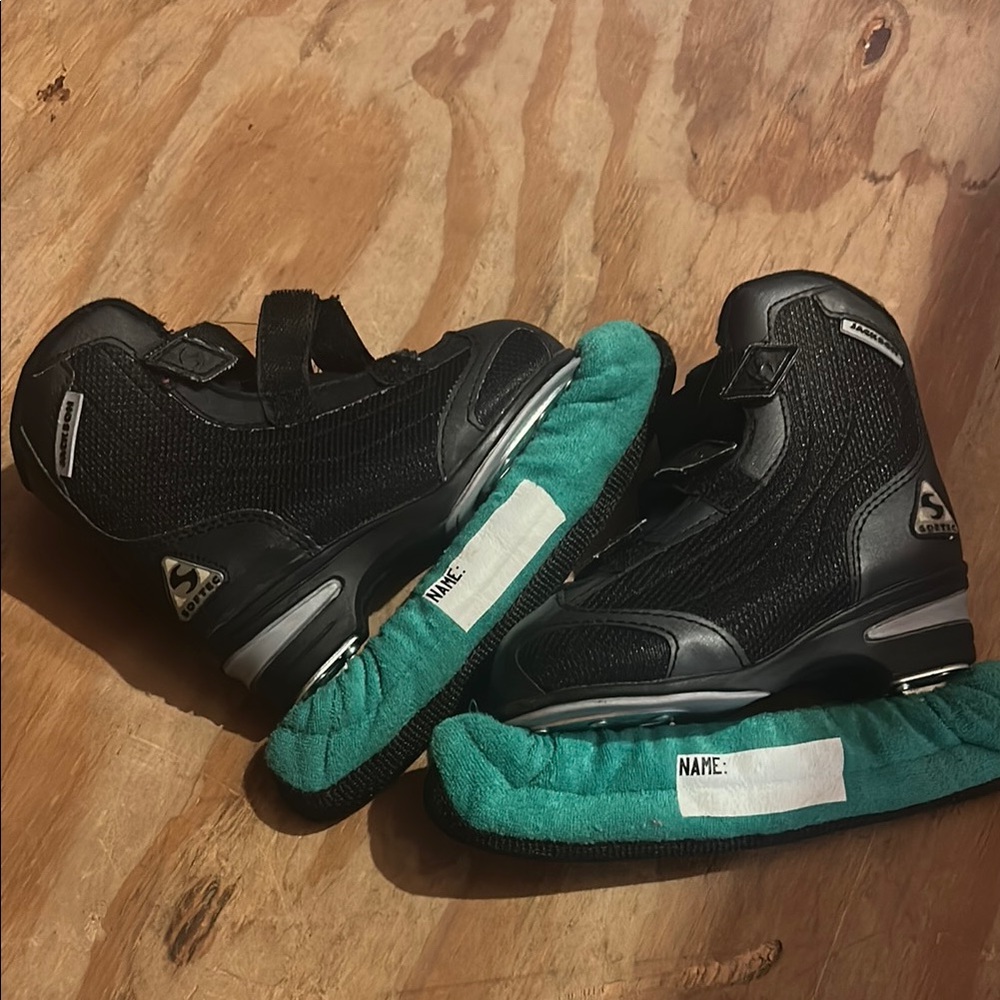 Black toddler ice skates with Teal Covers